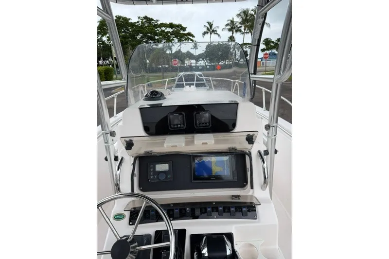 Slide: The Image of 2003 Grady-White Advance 257 boat dashboard with navigation equipment and steering wheel. - 7