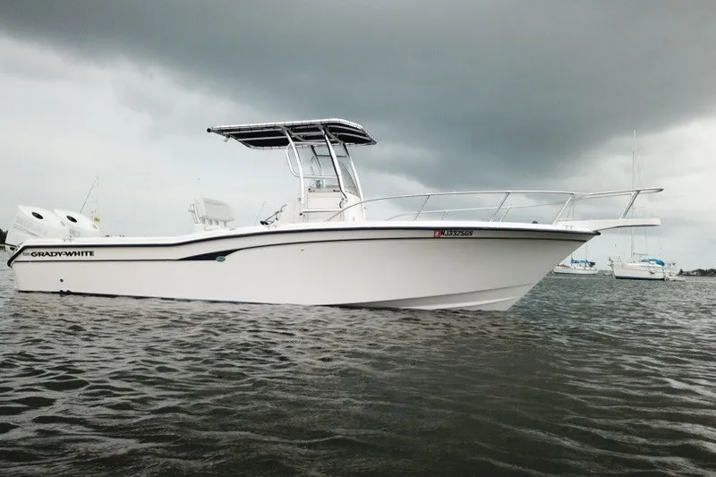 Slide: The Image of 2003 Grady-White Advance 257 boat on water under cloudy sky. - 6