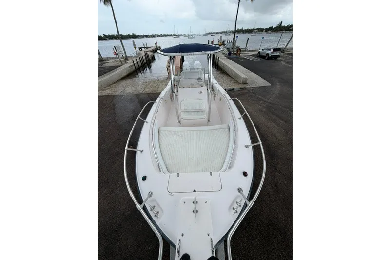 Slide: The Image of 2003 Grady-White Advance 257 boat docked by the waterfront, featuring spacious deck and seating. - 10