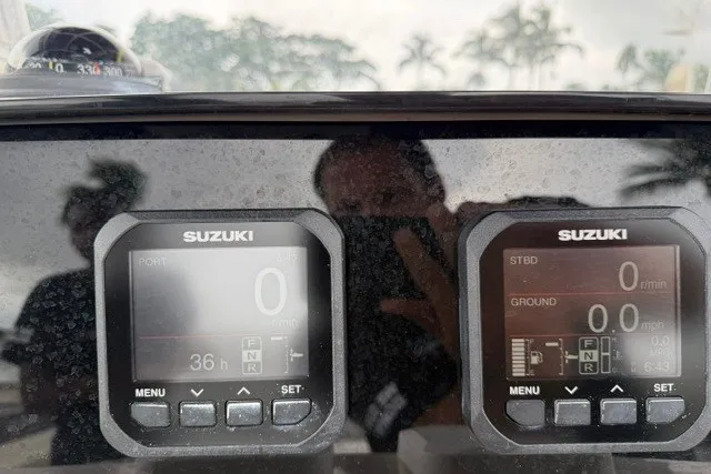 Slide: The Image of Close-up of Suzuki marine gauges on a 2003 Grady-White Advance 257 boat dashboard. - 8