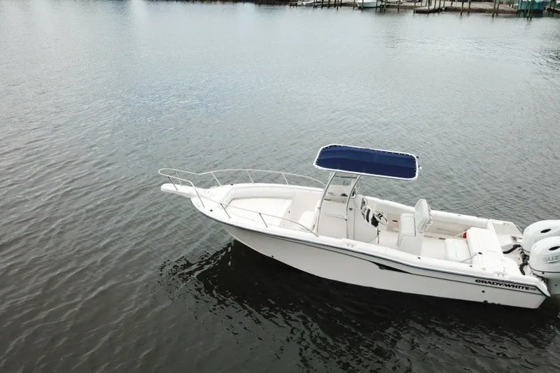 Slide: The Image of 2003 Grady-White Advance 257 boat on calm water with blue canopy. - 2