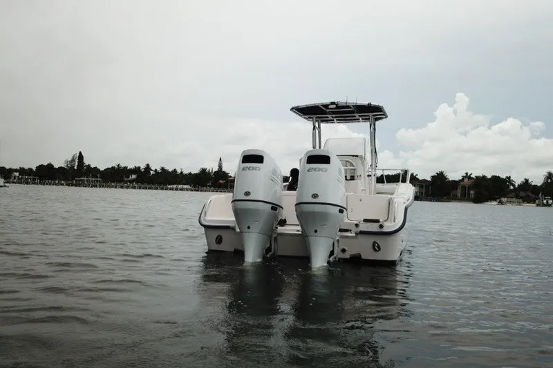 Slide: The Image of 2003 Grady-White Advance 257 boat with twin engines on calm water. - 3