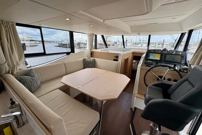 Slide: The Image of Interior of 2025 Beneteau Swift Trawler 48 with helm, seating, and dining area. - 17