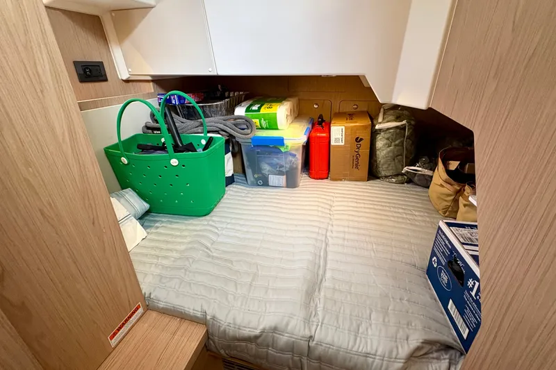 Slide: The Image of Storage area in 2025 Beneteau Swift Trawler 48, featuring organized supplies and equipment. - 11