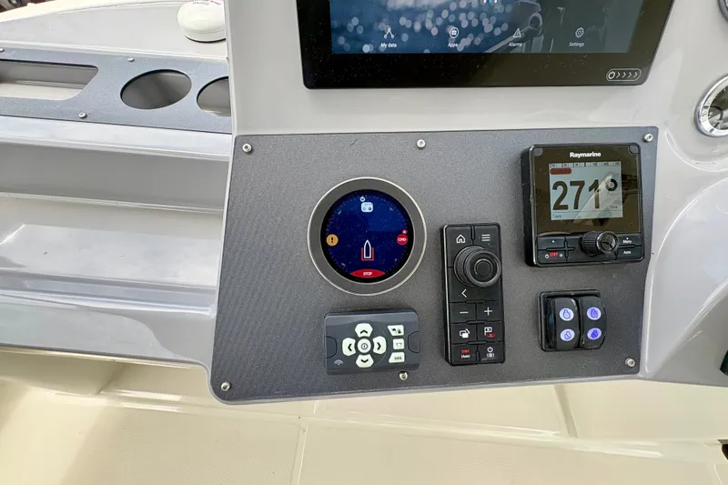 Slide: The Image of Control panel of 2025 Beneteau Swift Trawler 48 with navigation and control instruments. - 29