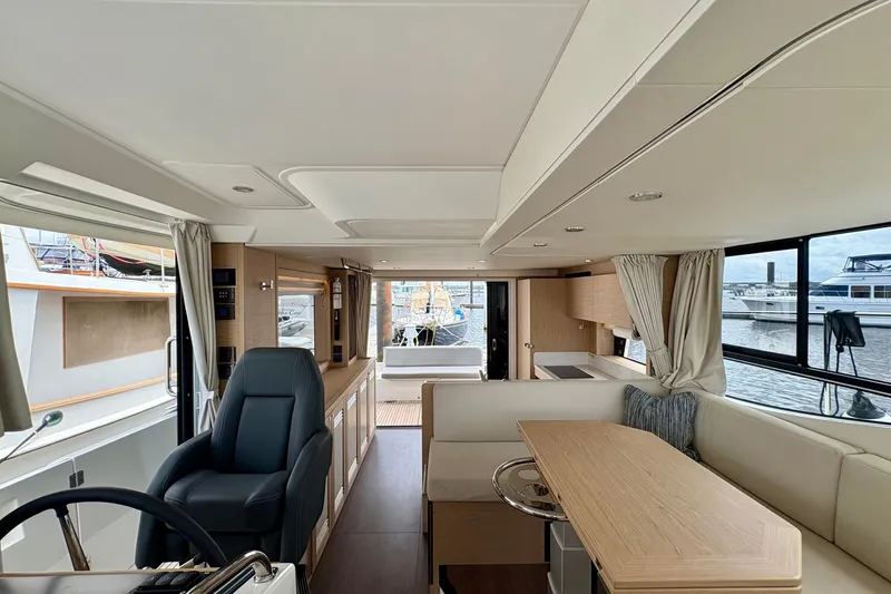 Slide: The Image of Interior of 2025 Beneteau Swift Trawler 48, featuring modern seating and dining area. - 5