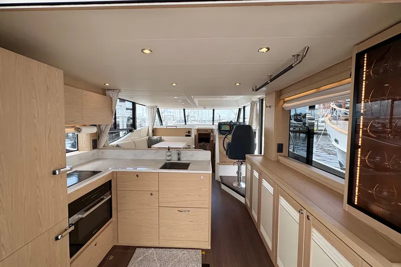 Slide: The Image of Luxurious interior of 2025 Beneteau Swift Trawler 48 with modern kitchen and helm station. - 20