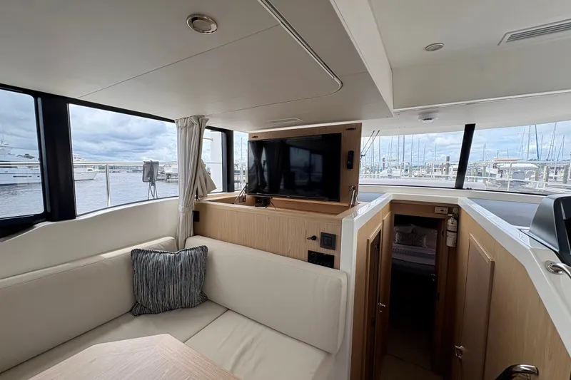 Slide: The Image of Interior of 2025 Beneteau Swift Trawler 48 with modern seating and large windows. - 14