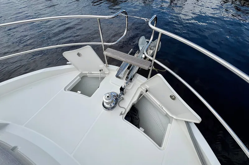 Slide: The Image of Bow view of 2025 Beneteau Swift Trawler 48, featuring anchor and storage compartments. - 22