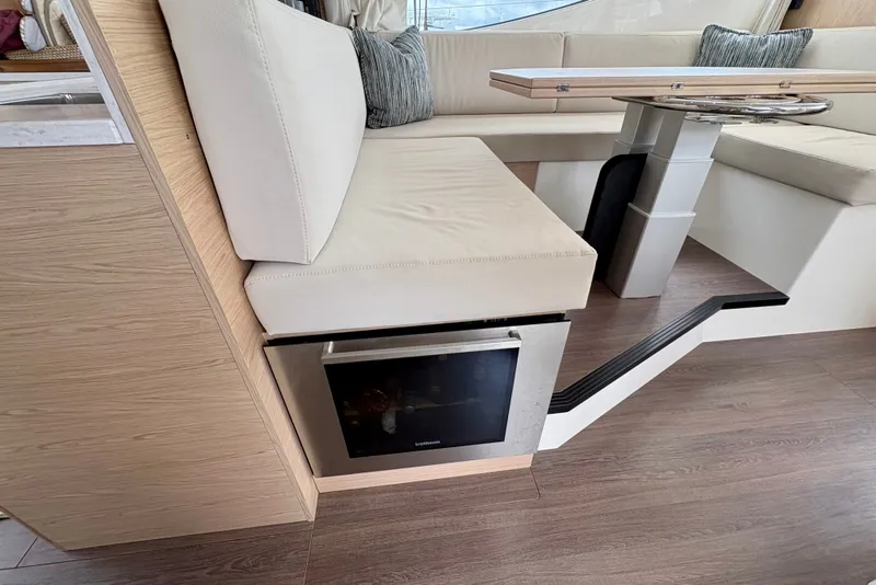 Slide: The Image of Luxurious interior of 2025 Beneteau Swift Trawler 48 with modern seating and table design. - 16