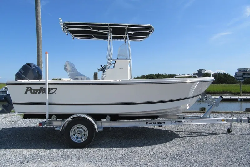 The Image of 2027 Parker 180 Coastal boat on trailer, parked outdoors under clear blue sky. - 2