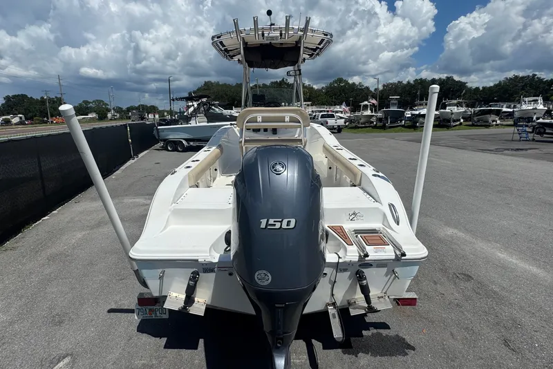Slide: The Image of A 2016 Sea Fox 206 Commander with a 150 HP outboard motor, parked on an asphalt lot. - 5