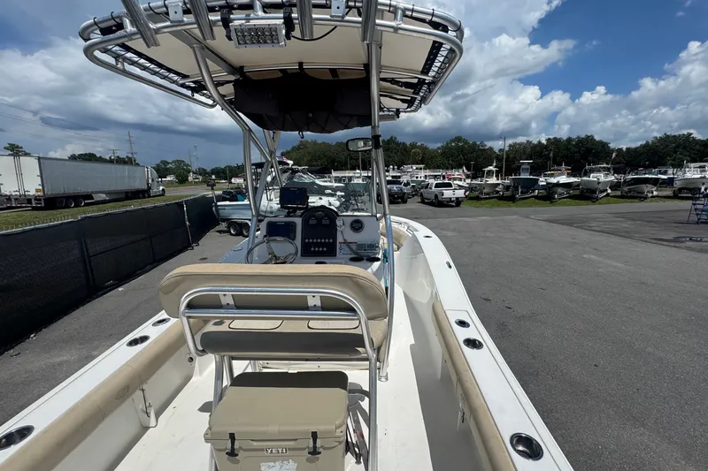 Slide: The Image of The image shows a 2016 Sea Fox 206 Commander boat. It is parked with other boats in the background. - 18