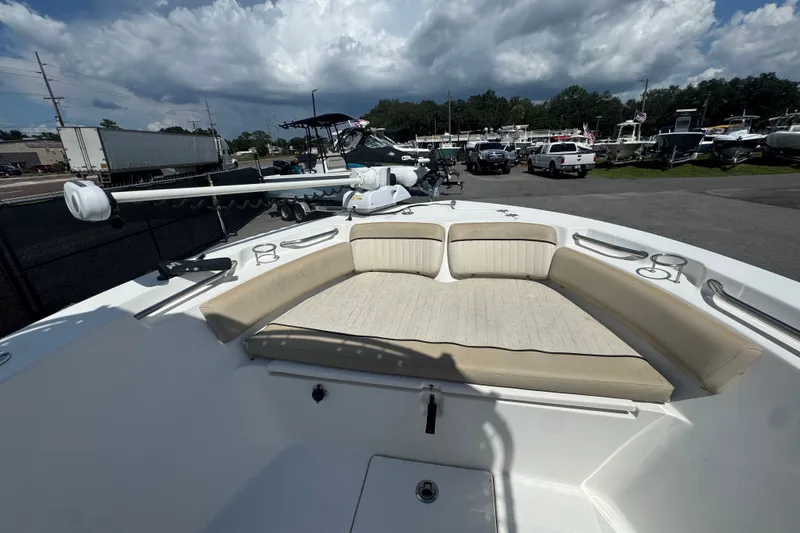 Slide: The Image of 2016 Sea Fox 206 Commander boat with cushioned seating, parked outdoors under cloudy skies. - 29