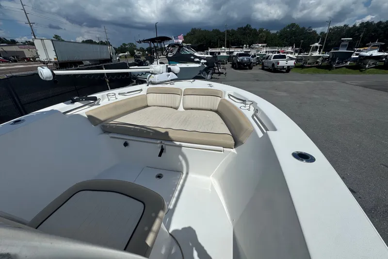Slide: The Image of 2016 Sea Fox 206 Commander boat with beige seating, parked outdoors under cloudy skies. - 28