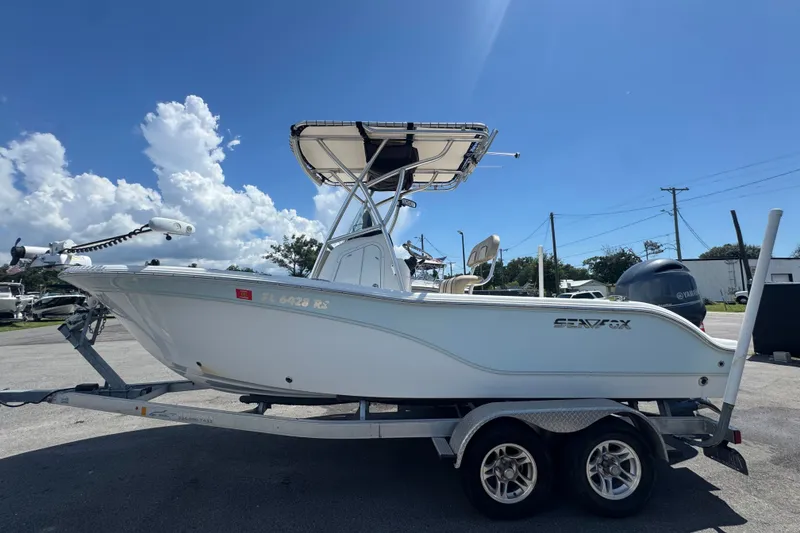 Slide: The Image of 2016 Sea Fox 206 Commander boat on trailer under clear blue sky. - 12
