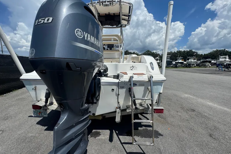 Slide: The Image of A 2016 Sea Fox 206 Commander with a Yamaha outboard motor, parked under a blue sky. - 3