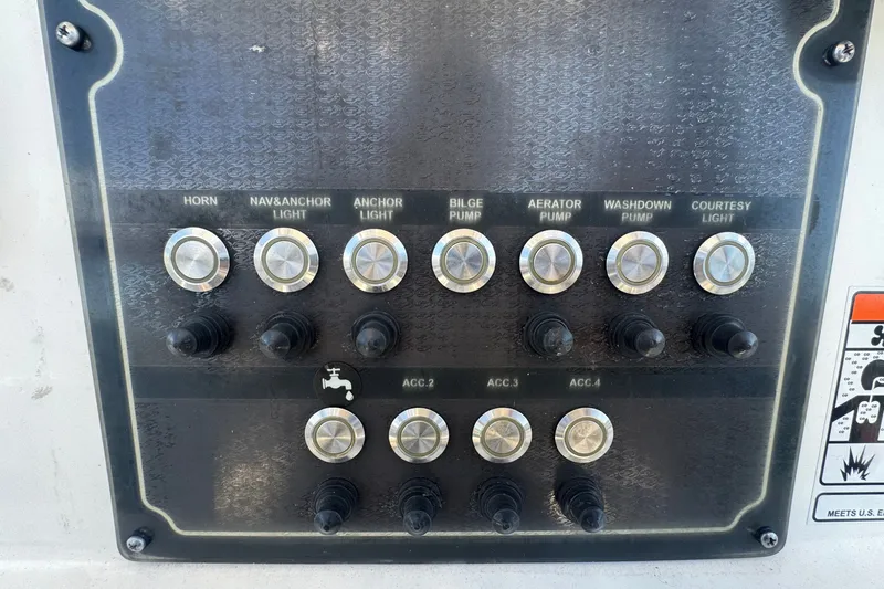 Slide: The Image of Control panel of a 2016 Sea Fox 206 Commander boat with labeled switches. - 25