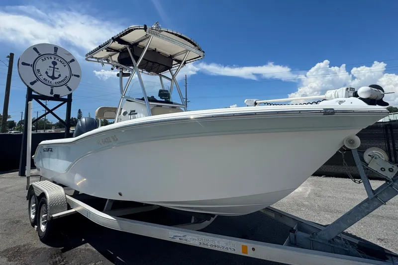 The Image of 2016 Sea Fox 206 Commander on a trailer, featuring a T-top and outboard motor. - 0