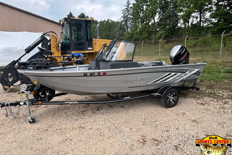 Slide: The Image of 2023 Smoker Craft Excursion 176 DC Pro boat on trailer, parked outdoors. - 1