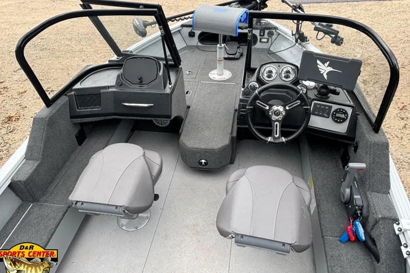 Slide: The Image of 2023 Smoker Craft Excursion 176 DC Pro boat interior with steering wheel and seating. - 6