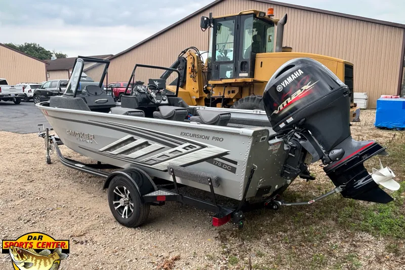 Slide: The Image of 2023 Smoker Craft Excursion 176 DC Pro boat with Yamaha outboard motor on trailer. - 2