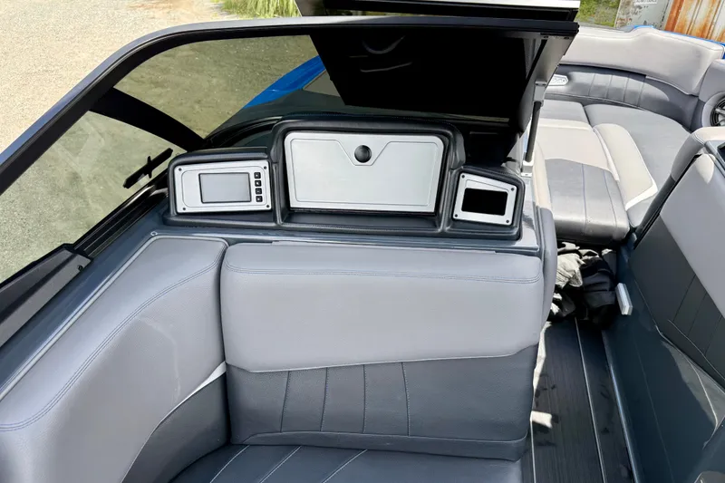 Slide: The Image of 2022 Supra SE 450 boat interior with gray seating and dashboard controls. - 21