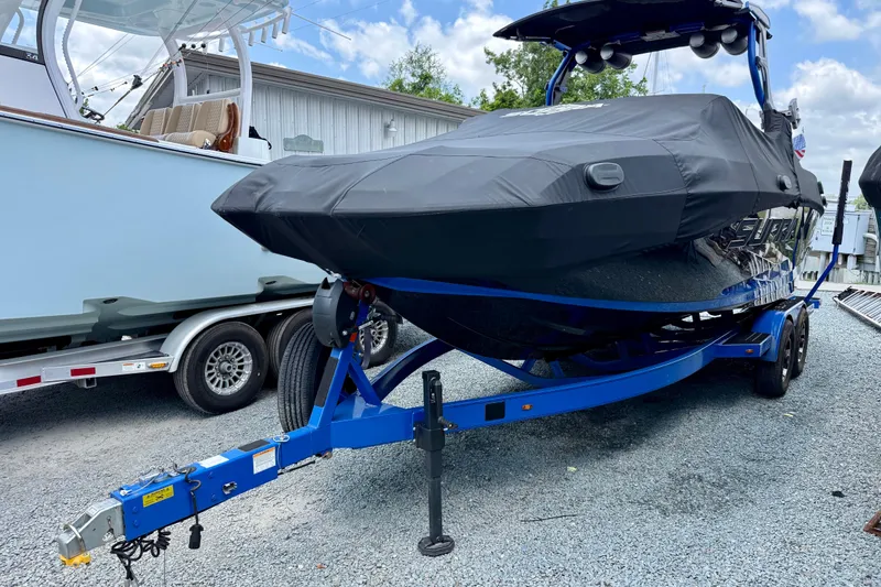 Slide: The Image of 2022 Supra SE 450 boat on trailer, covered, parked on gravel. - 8