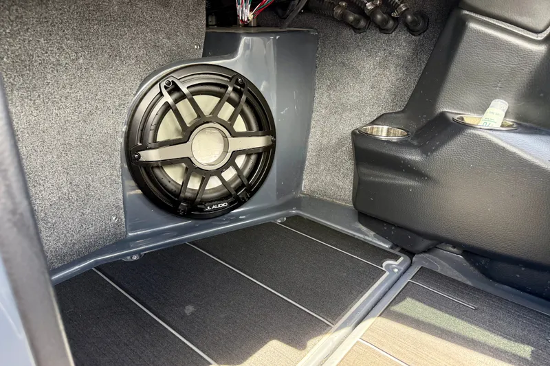 Slide: The Image of 2022 Supra SE 450 interior with JL Audio speaker and cup holders. - 19