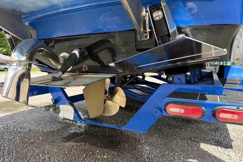 Slide: The Image of Rear view of a 2022 Supra SE 450 boat, showcasing propeller and exhaust system. - 36