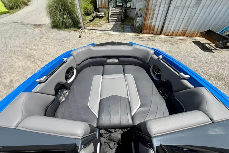 Slide: The Image of 2022 Supra SE 450 boat interior with gray seating and blue accents. - 24