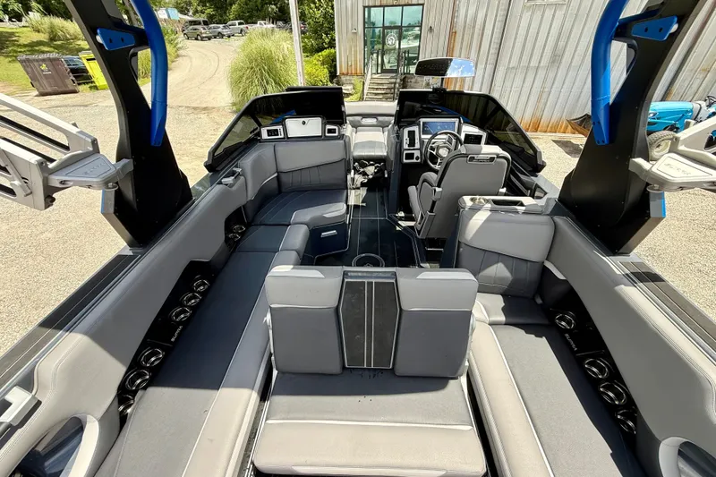Slide: The Image of 2022 Supra SE 450 boat interior with sleek seating and modern dashboard design. - 13