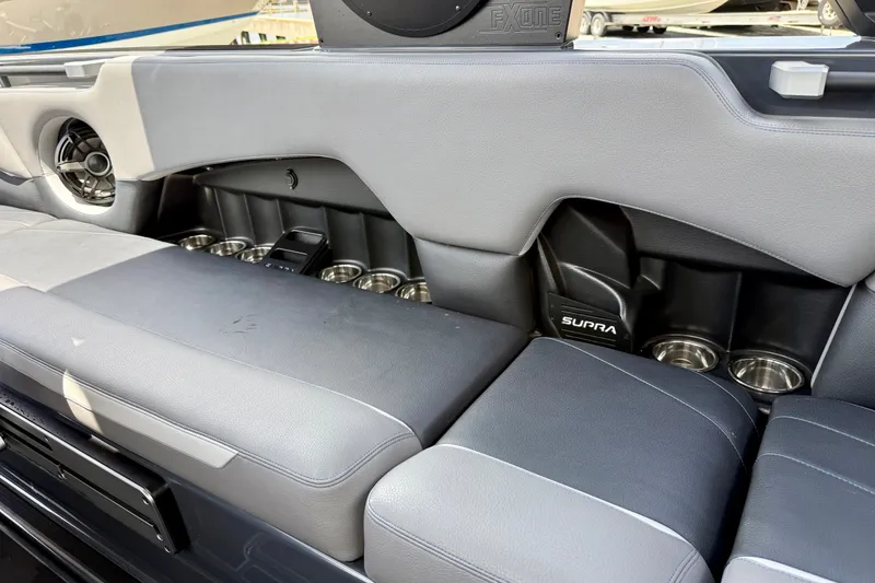 Slide: The Image of Interior of 2022 Supra SE 450 boat with sleek seating and integrated cup holders. - 29