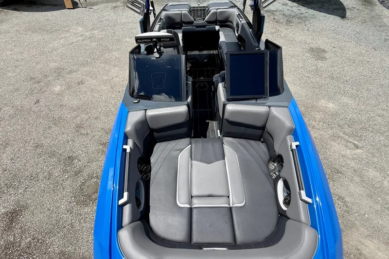Slide: The Image of 2022 Supra SE 450 boat interior with gray seating and blue exterior. - 27