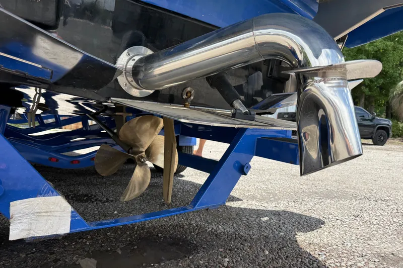 Slide: The Image of 2022 Supra SE 450 boat propeller and exhaust system on a trailer. - 35