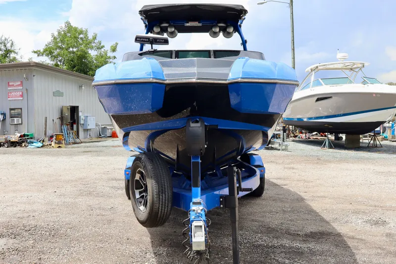 Slide: The Image of 2022 Supra SE 450 boat on trailer in a marina setting. - 7