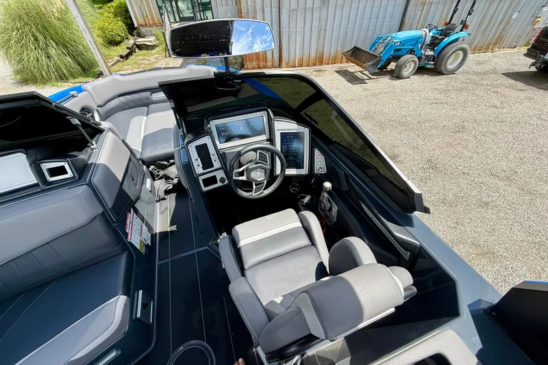 Slide: The Image of Interior of a 2022 Supra SE 450 boat with modern dashboard and seating. - 16
