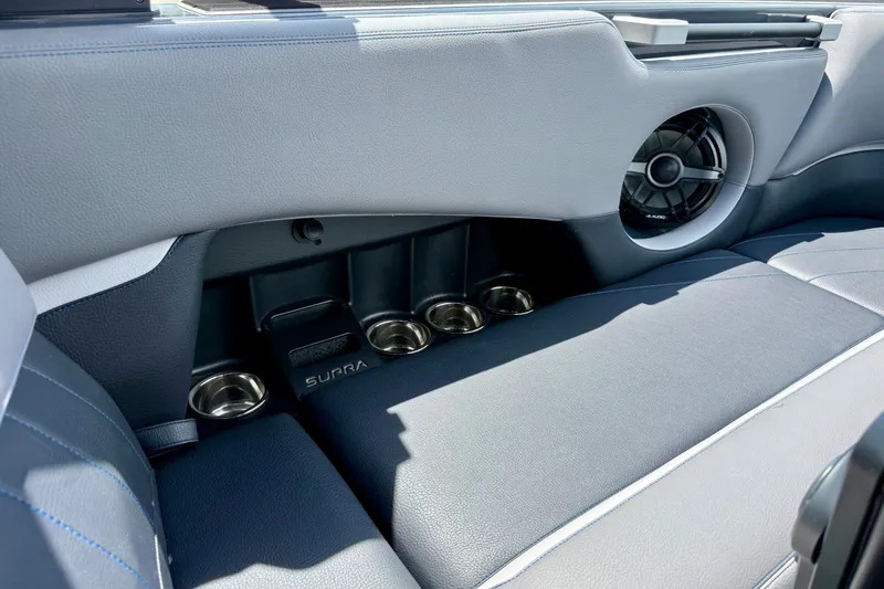 Slide: The Image of 2022 Supra SE 450 interior with cup holders and speaker detail. - 28
