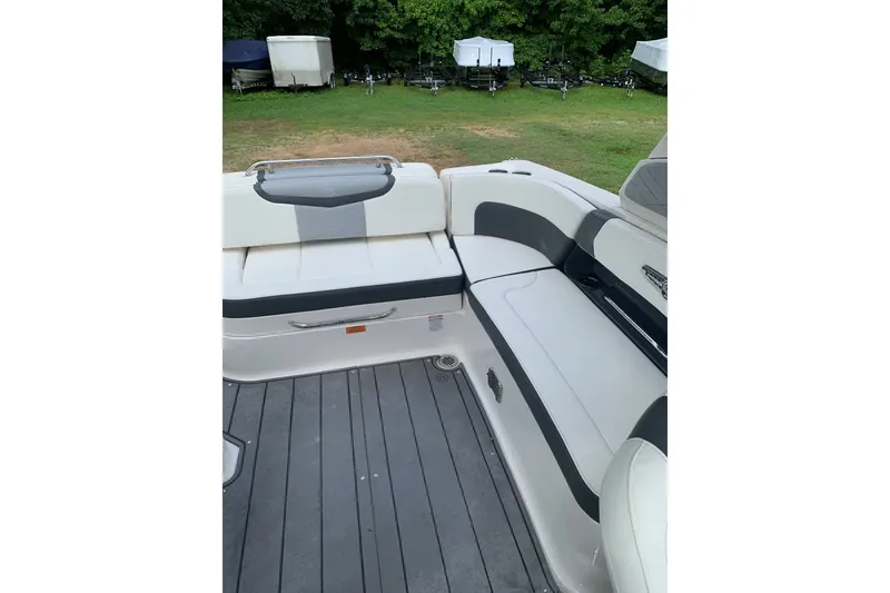 Slide: The Image of Interior seating of 2022 Chaparral 28 Surf boat with sleek white and gray design. - 2