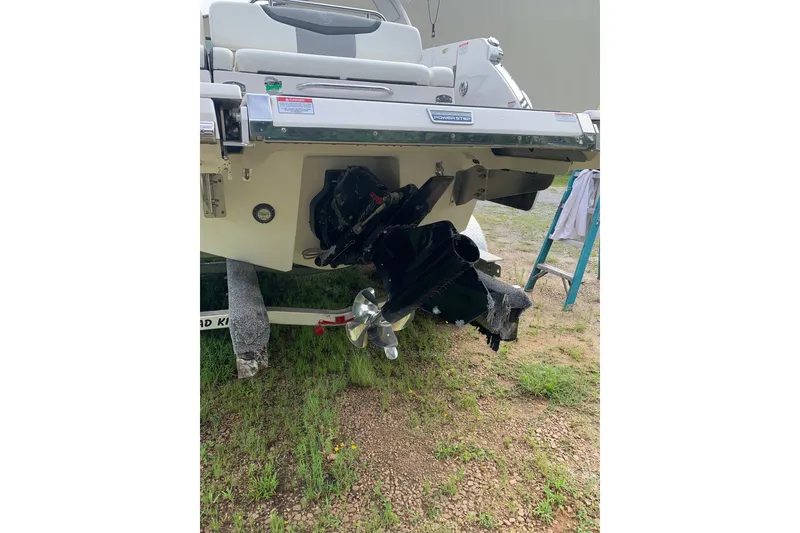 Slide: The Image of 2022 Chaparral 28 Surf boat stern view with propeller and outdrive on trailer. - 8