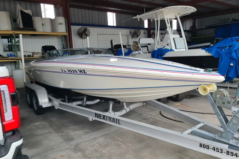 The Image of 1994 Checkmate Pulsare 2100 boat on trailer in storage facility. - 0