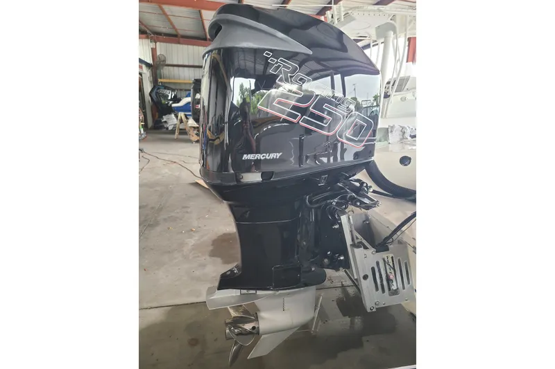 Slide: The Image of Mercury XR9 250 outboard motor on 1994 Checkmate Pulsare 2100 boat in a garage. - 23
