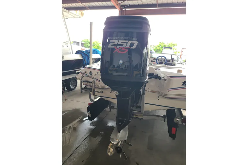 Slide: The Image of 1994 Checkmate Pulsare 2100 boat with 250 XS outboard motor in a garage. - 20