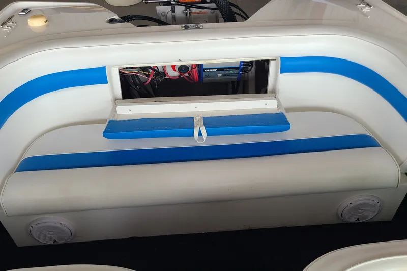 Slide: The Image of 1994 Checkmate Pulsare 2100 boat interior with blue and white seating and exposed wiring. - 15