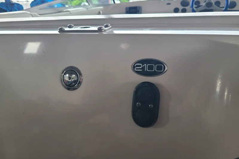 Slide: The Image of 1994 Checkmate Pulsare 2100 boat dashboard with emblem and controls. - 14