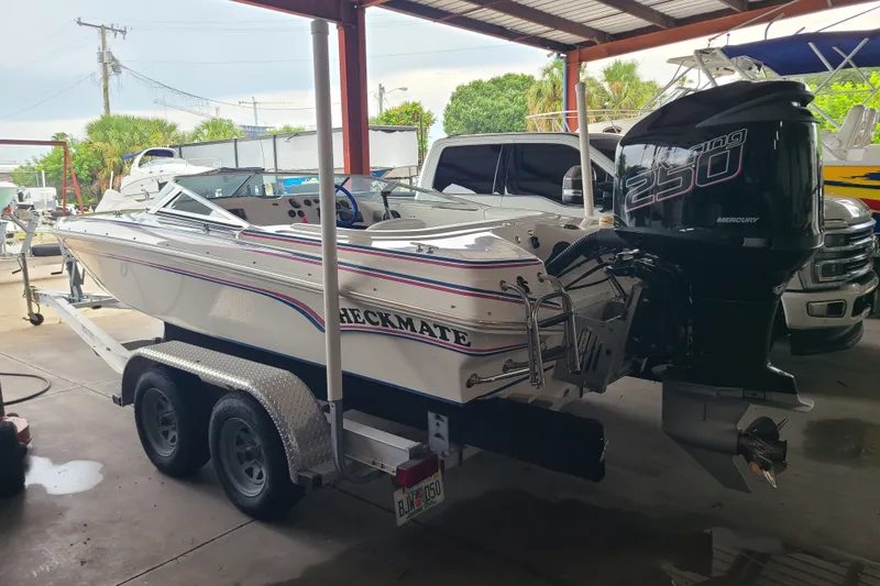 Slide: The Image of 1994 Checkmate Pulsare 2100 boat with Mercury 250 engine on a trailer in a garage. - 18