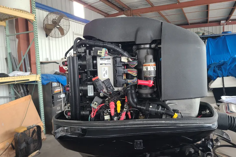 Slide: The Image of 1994 Checkmate Pulsare 2100 engine with exposed wiring in a workshop setting. - 24