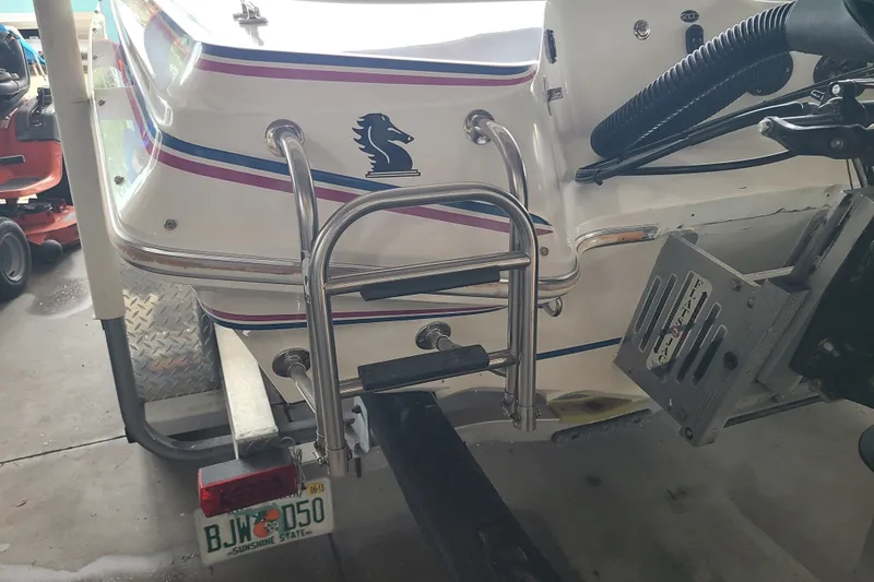 Slide: The Image of 1994 Checkmate Pulsare 2100 boat with ladder and Florida license plate in garage. - 28