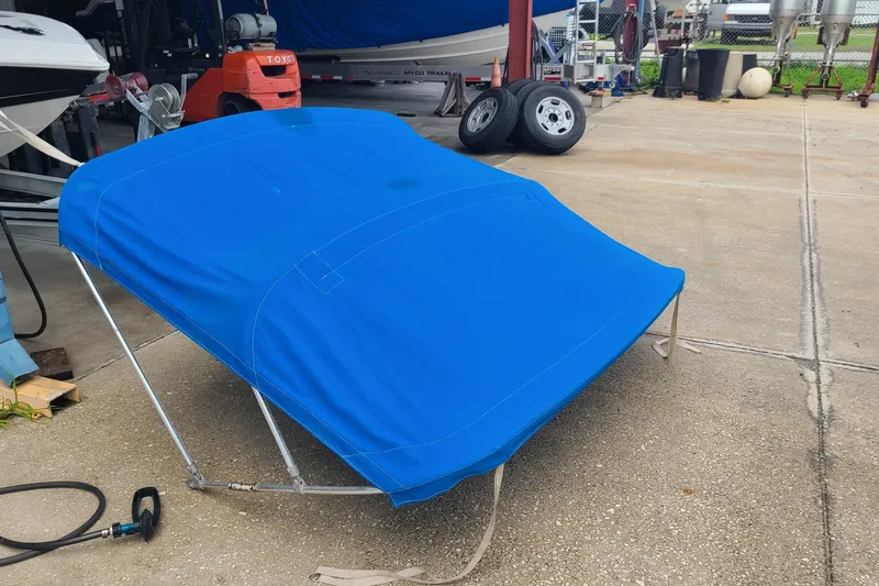 Slide: The Image of Blue boat cover for 1994 Checkmate Pulsare 2100, displayed on concrete surface. - 31