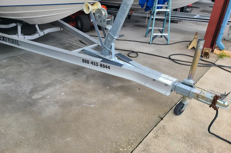 Slide: The Image of Trailer for 1994 Checkmate Pulsare 2100 boat, parked on concrete surface. - 29